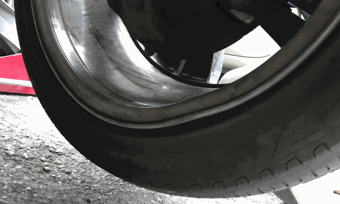 Buckled alloy wheel before straightening